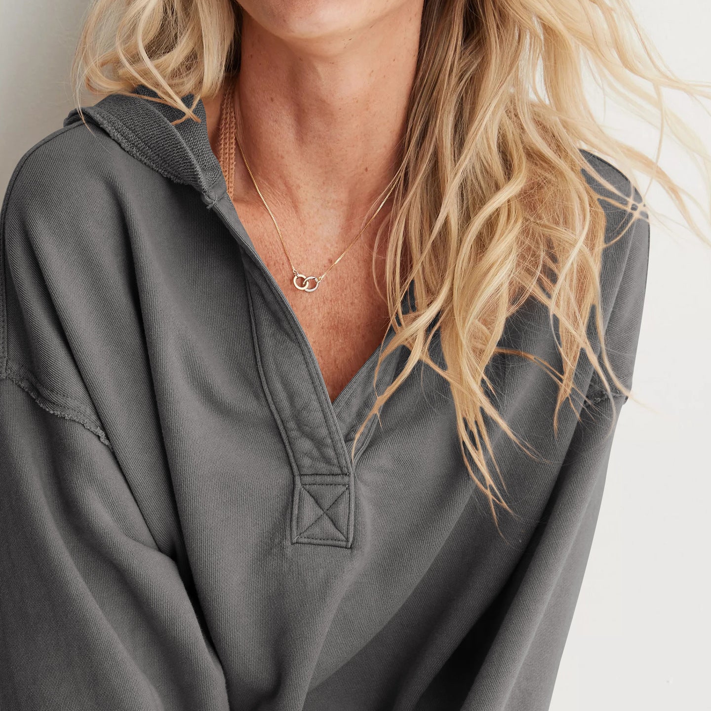 Gray hooded henley pullover with decorative stitching, ideal for cozy fashion ملابس