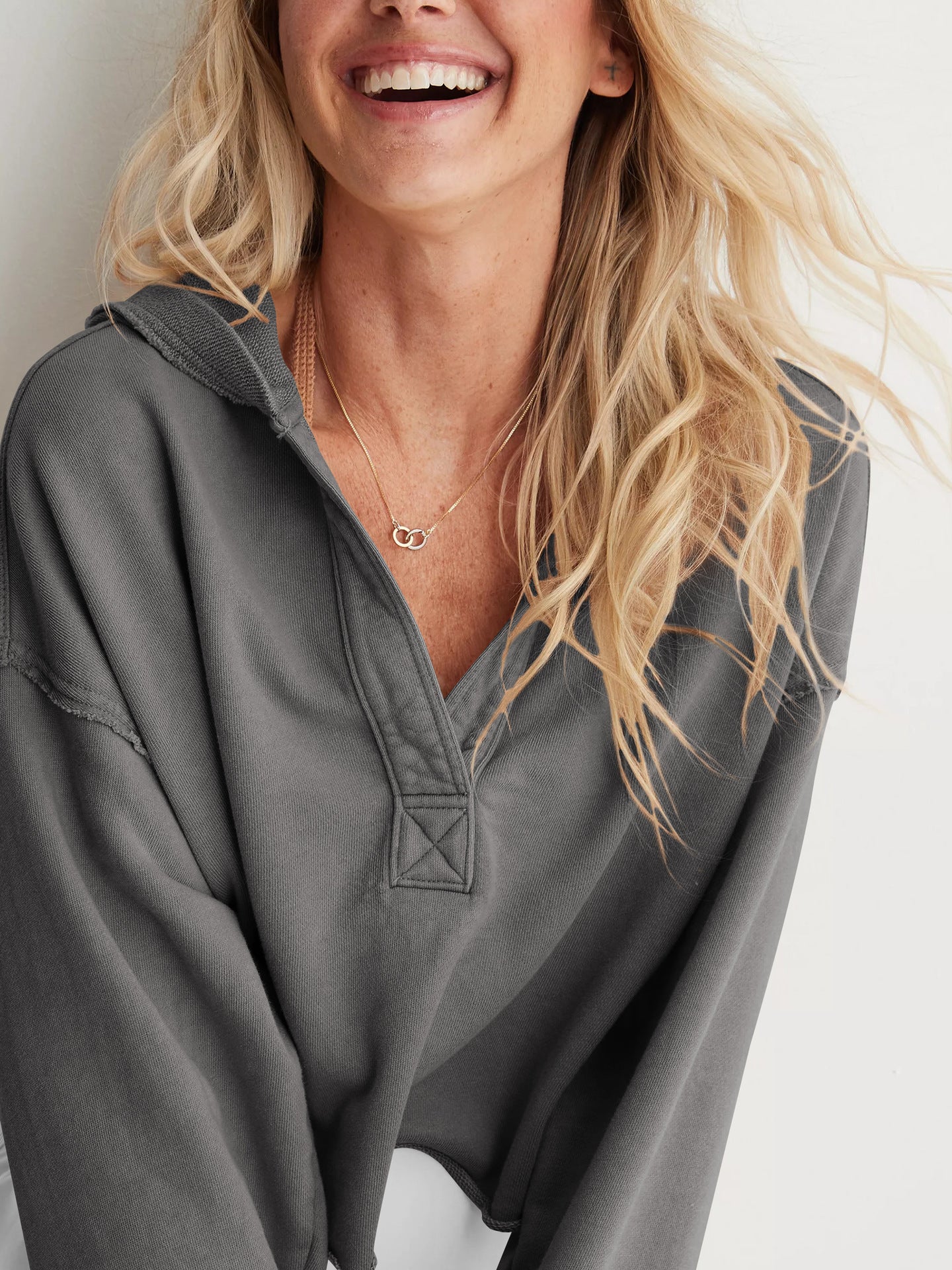 Gray hooded henley pullover with decorative stitching, ideal for cozy fashion ملابس