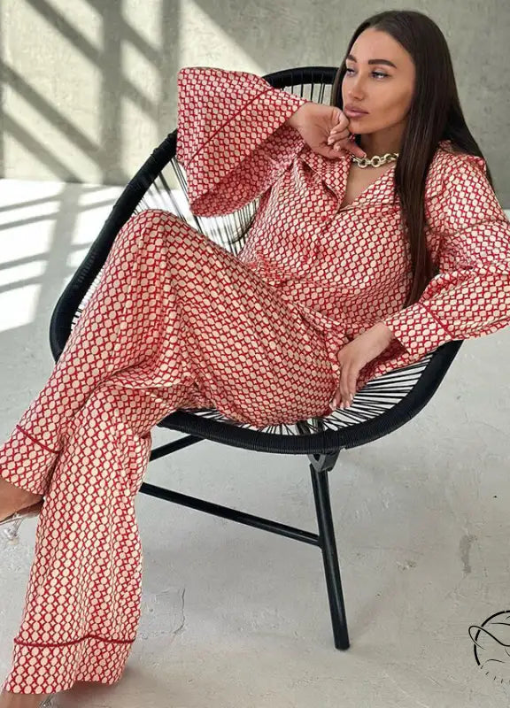 Woman in red white patterned pajama set with gold necklace and clear heels for casual comfortable homewear