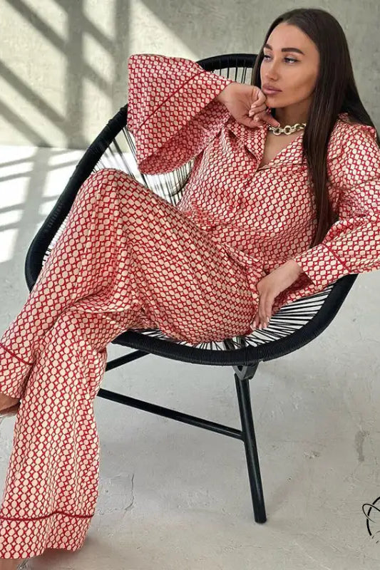 Woman in red white patterned pajama set with gold necklace and clear heels for casual comfortable homewear
