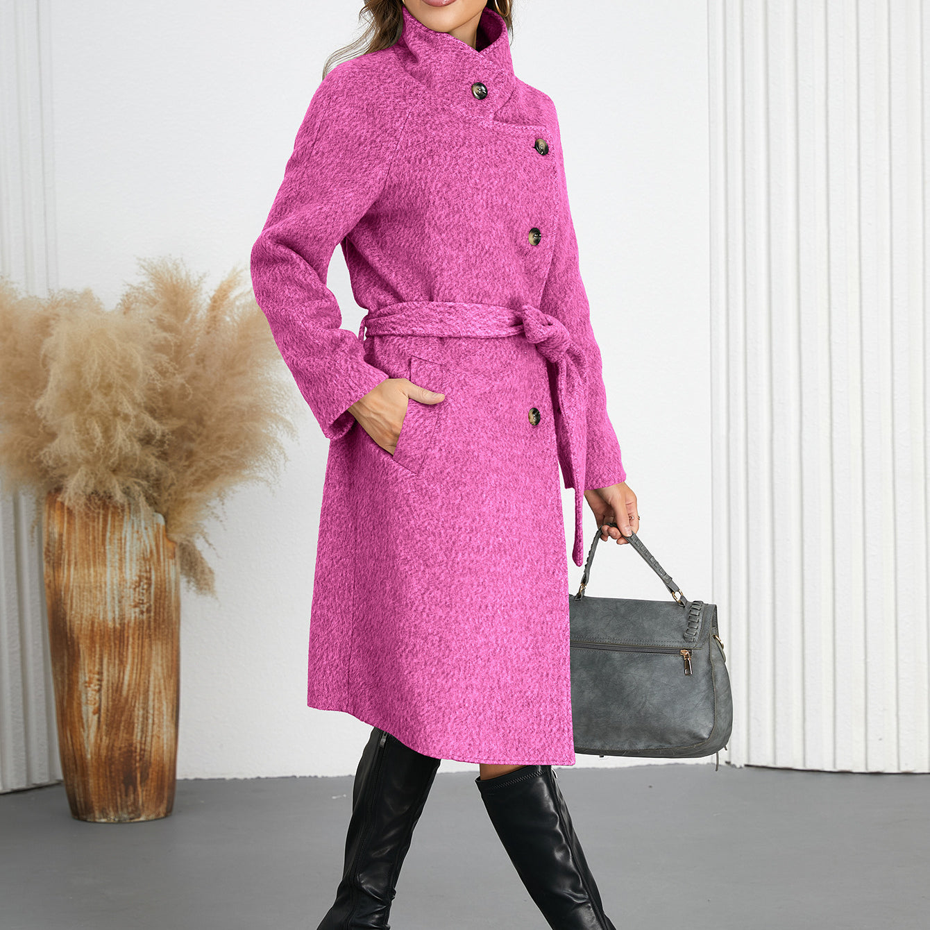 Woman wearing a pink belted woolen coat and black boots, trendy fashion ملابس