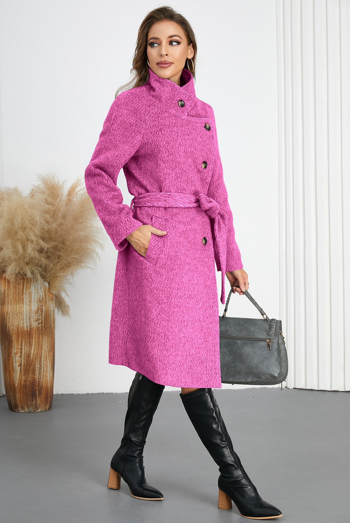 Woman wearing a pink belted woolen coat and black boots, trendy fashion ملابس