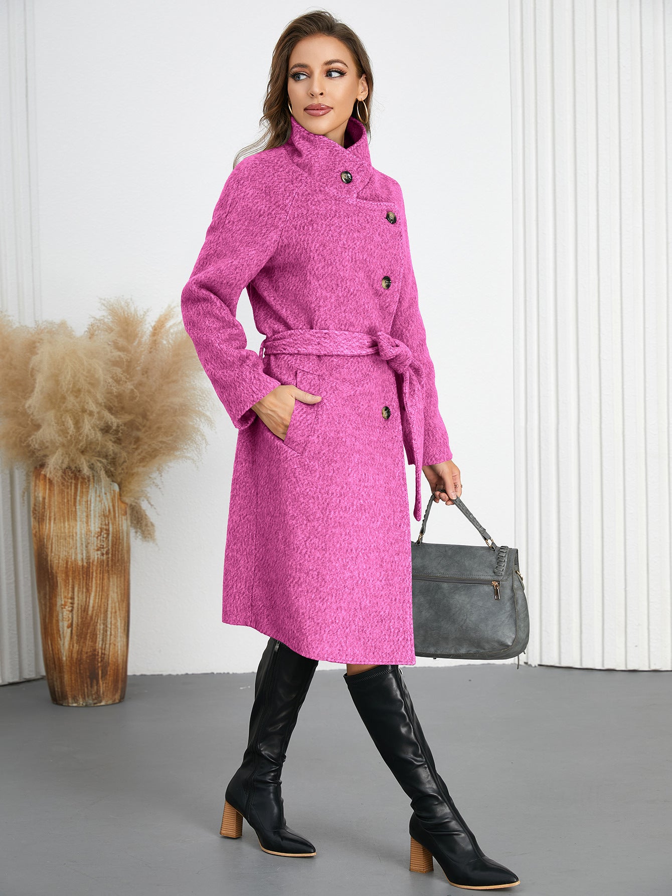 Woman wearing a pink belted woolen coat and black boots, trendy fashion ملابس