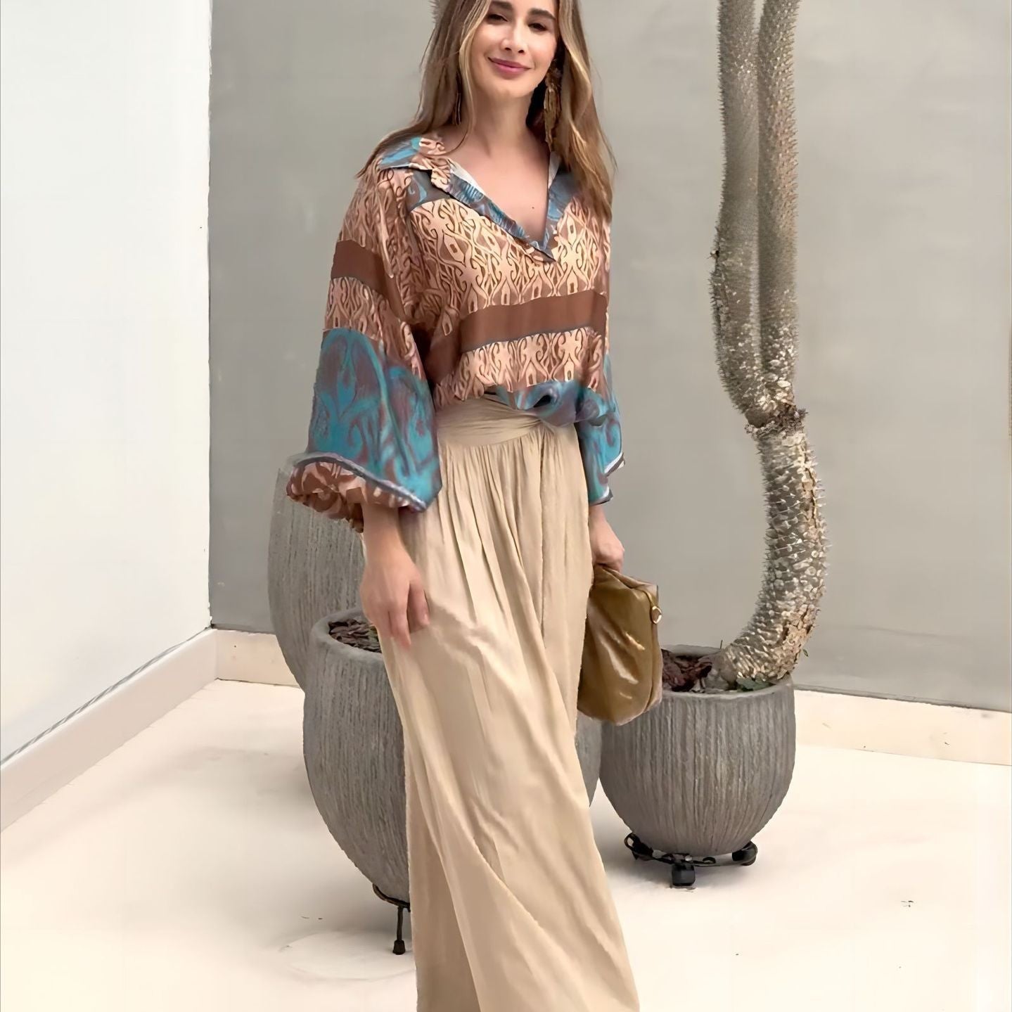 Elegant two piece set featuring woman in patterned blouse and wide-leg pants with free shipping