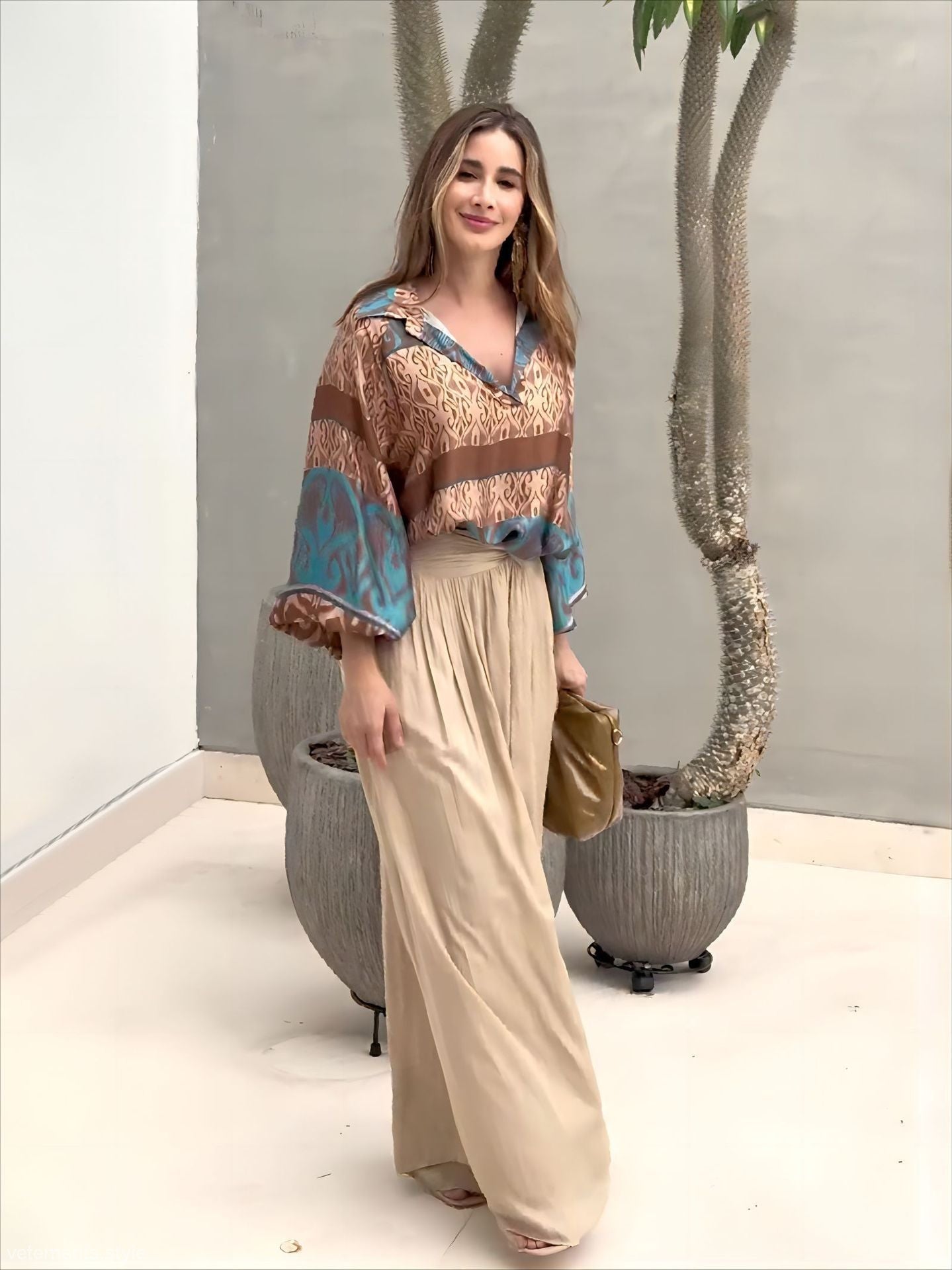 Elegant two piece set featuring woman in patterned blouse and wide-leg pants with free shipping