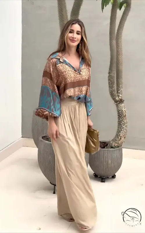 Elegant two piece set with woman in patterned blouse and wide-leg pants