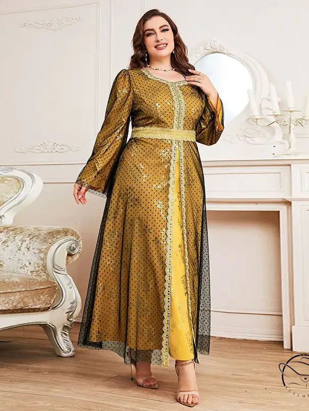 Woman in long sleeve A-line dress with golden-yellow polka dots