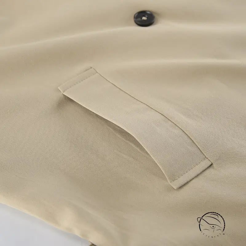 Beige trench coat with button-down shirt pocket and black button detail