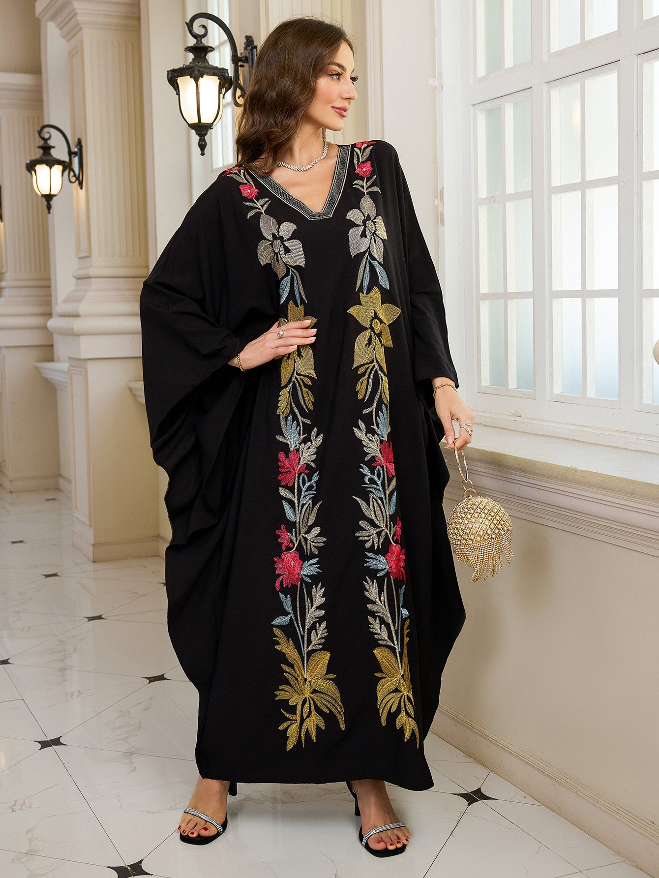 Elegant embroidered Middle East kaftan dress with black floral, gold accents, V-neckline