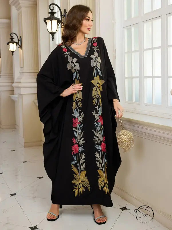 Elegant embroidered Middle East kaftan dress in black floral with gold accents