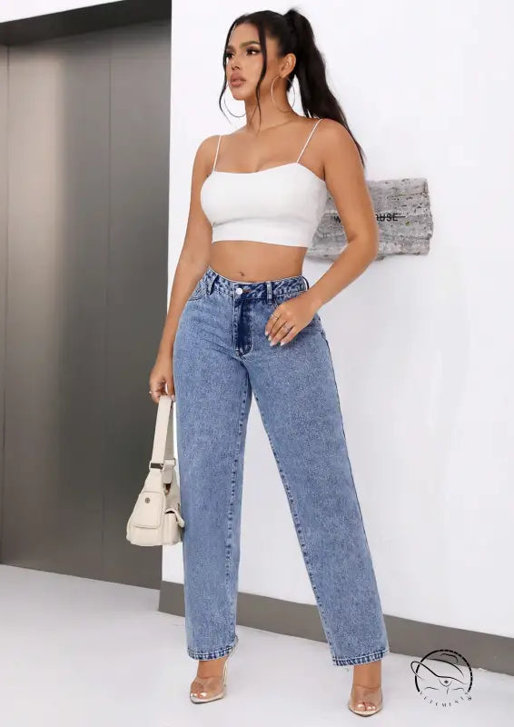 Woman in white crop top and retro high waist straight leg denim jeans