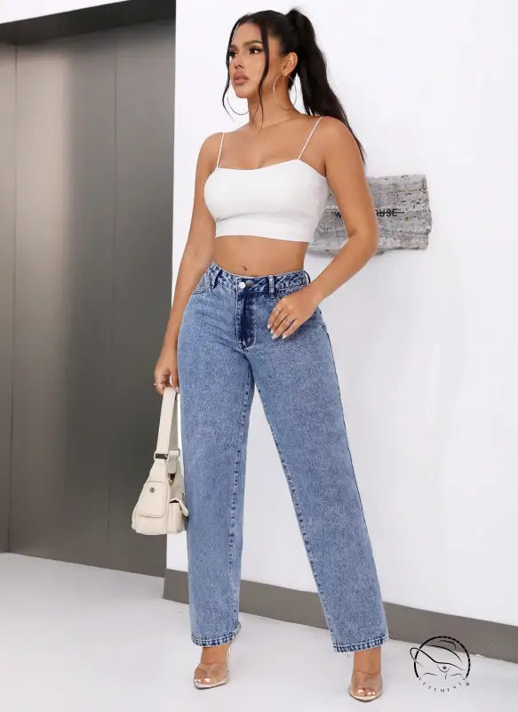 Woman in white crop top and retro high waist straight leg denim jeans