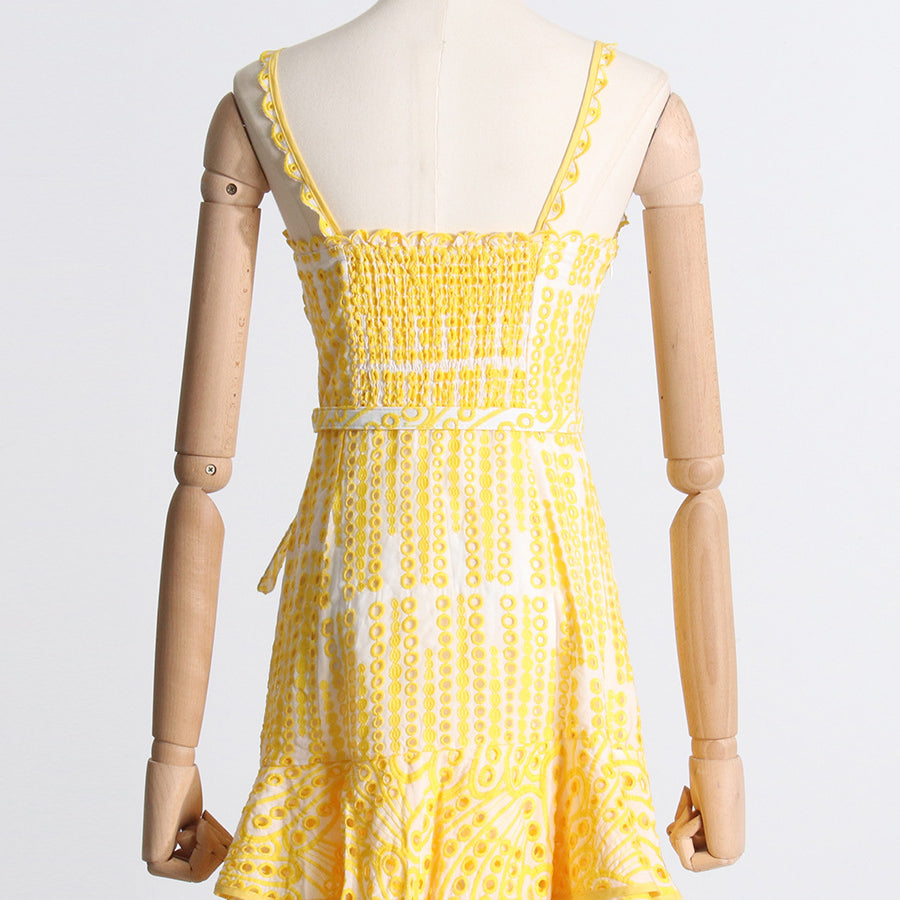 Yellow and white polka dot sundress with ruffled hem, perfect for summer fashion ملابس