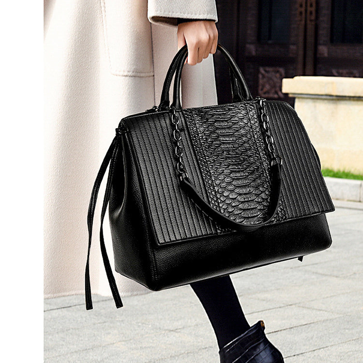 Langry fashion black python skin handbag with silver hardware and long tassels