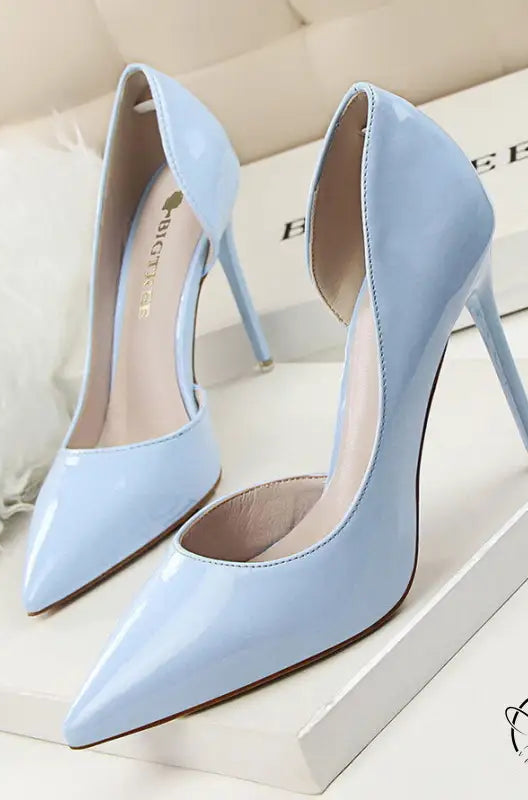 Pair of light blue patent leather low cut high heels with pointed toes