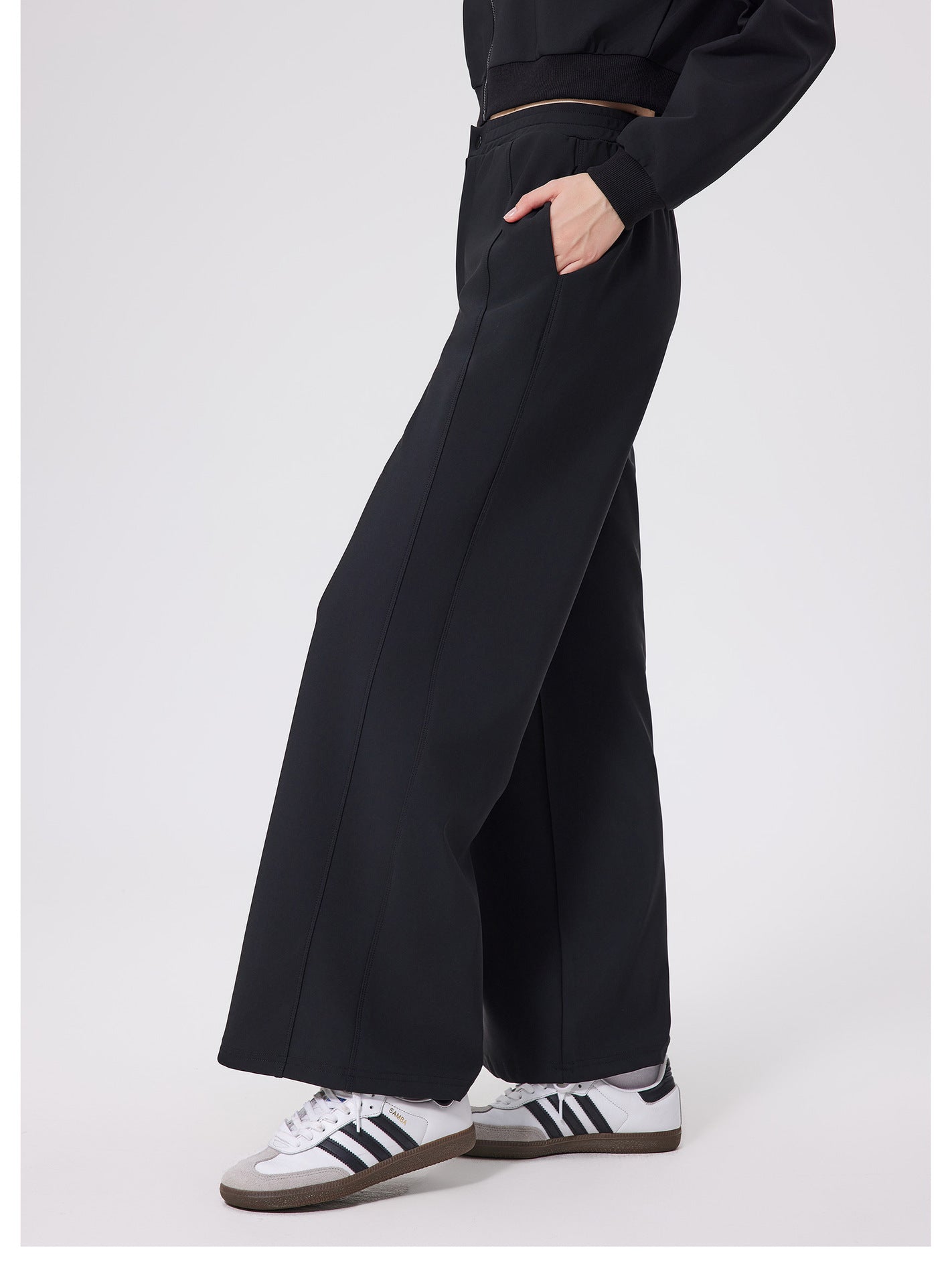 Black loose fitness warm pants with white Adidas sneakers and gold zipper detail