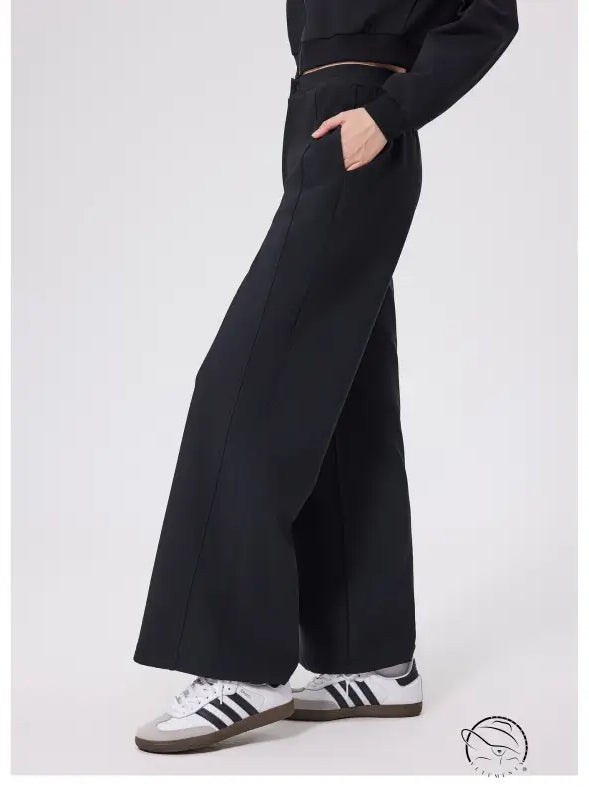 Black loose fitness warm pants with white Adidas sneakers and gold zipper