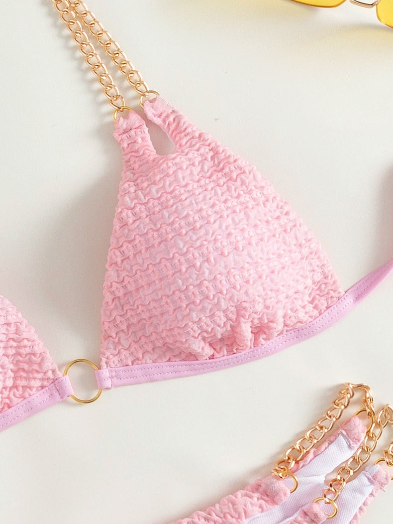 Pink textured bikini top with gold chain straps from the Backless Split Swimsuit collection