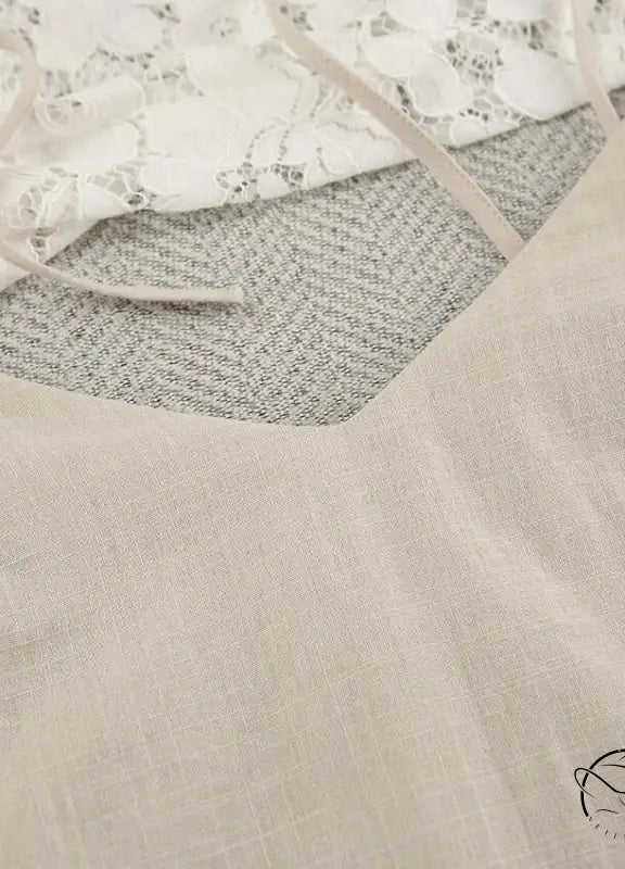 Light-colored backless cotton home wear camisole with thin straps and V-neckline