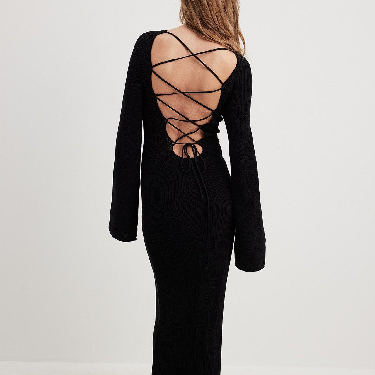 Long black dress with laced-up open back design, ideal for langry fashion ملابس