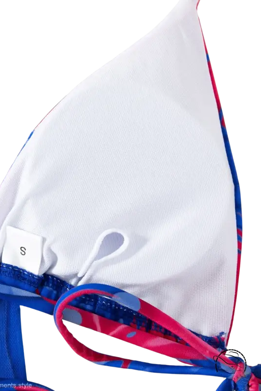 White triangle bikini top in four piece lace up swimsuit with blue and pink patterned straps, small size tag