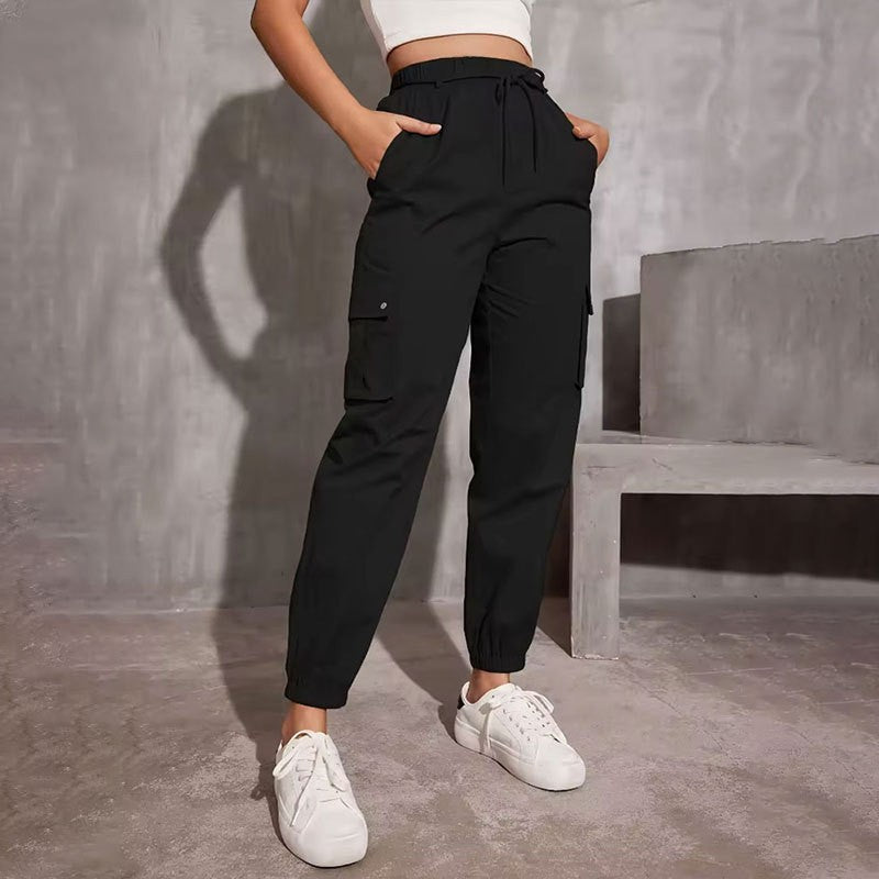 Black cargo jogger pants with elastic cuffs styled with white sneakers for modern fashion ملابس