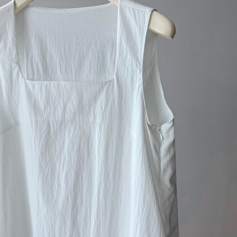 White sleeveless linen garment on a hanger, showcasing an Elegant Korean Style Dress