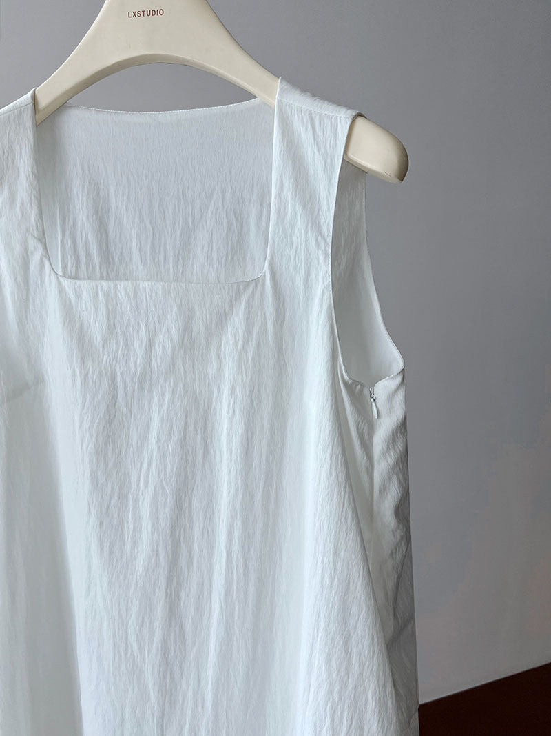 White sleeveless linen garment on a hanger, showcasing an Elegant Korean Style Dress