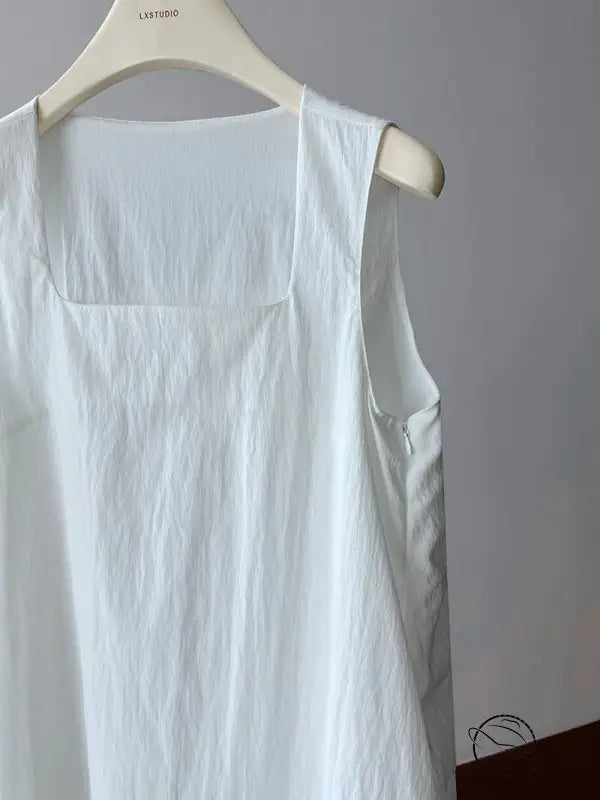Elegant Korean style dress: white sleeveless linen garment on hanger