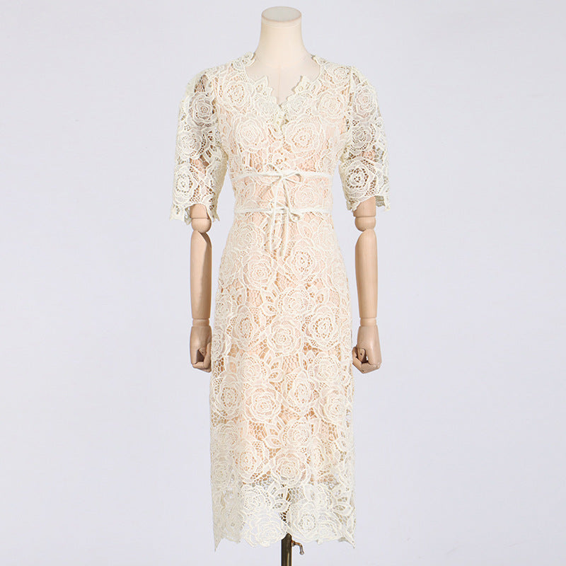 Cream-colored lace dress with elbow-length sleeves in elegant French fashion