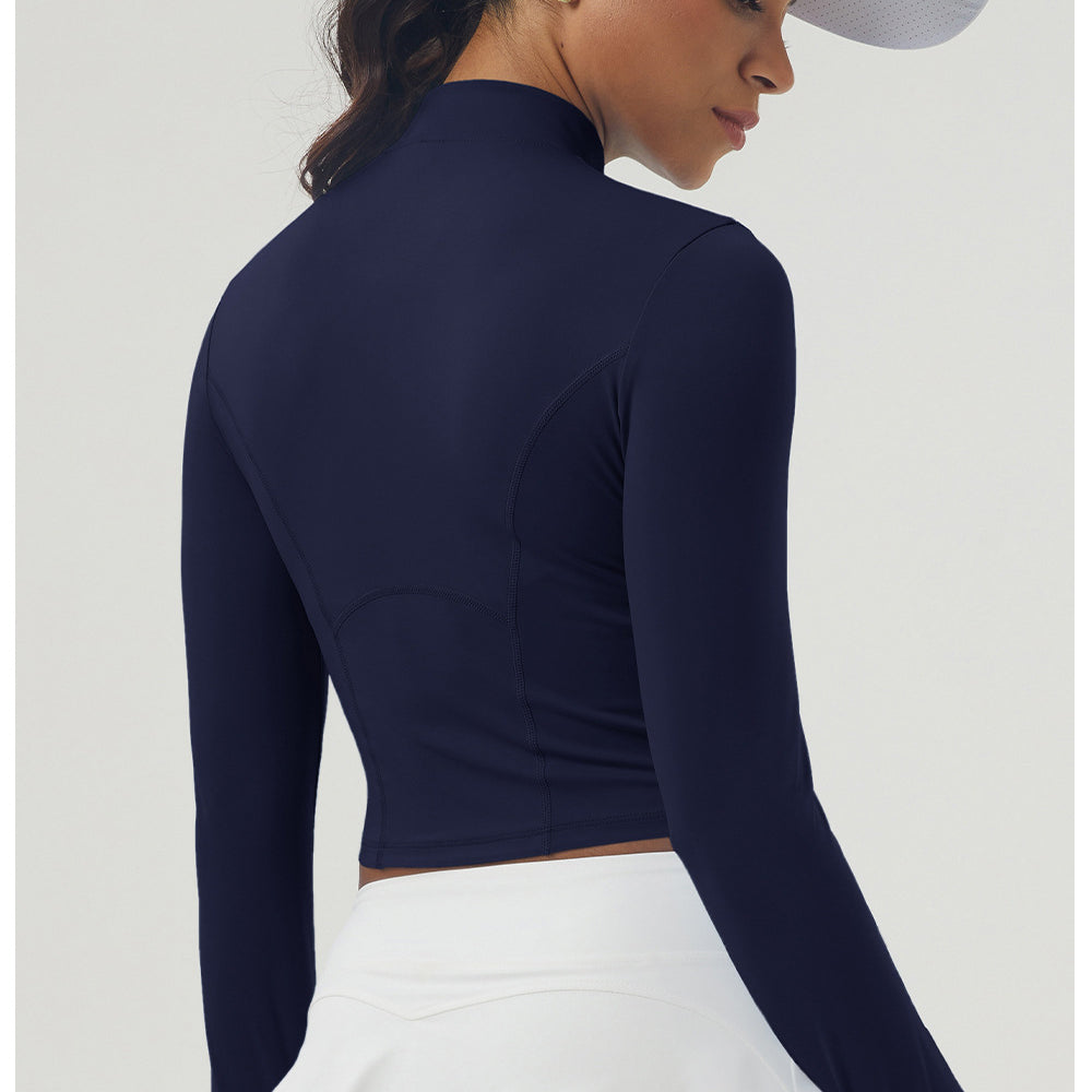 Navy blue long sleeve athletic top with mock neck, paired with white pleated skirt for women