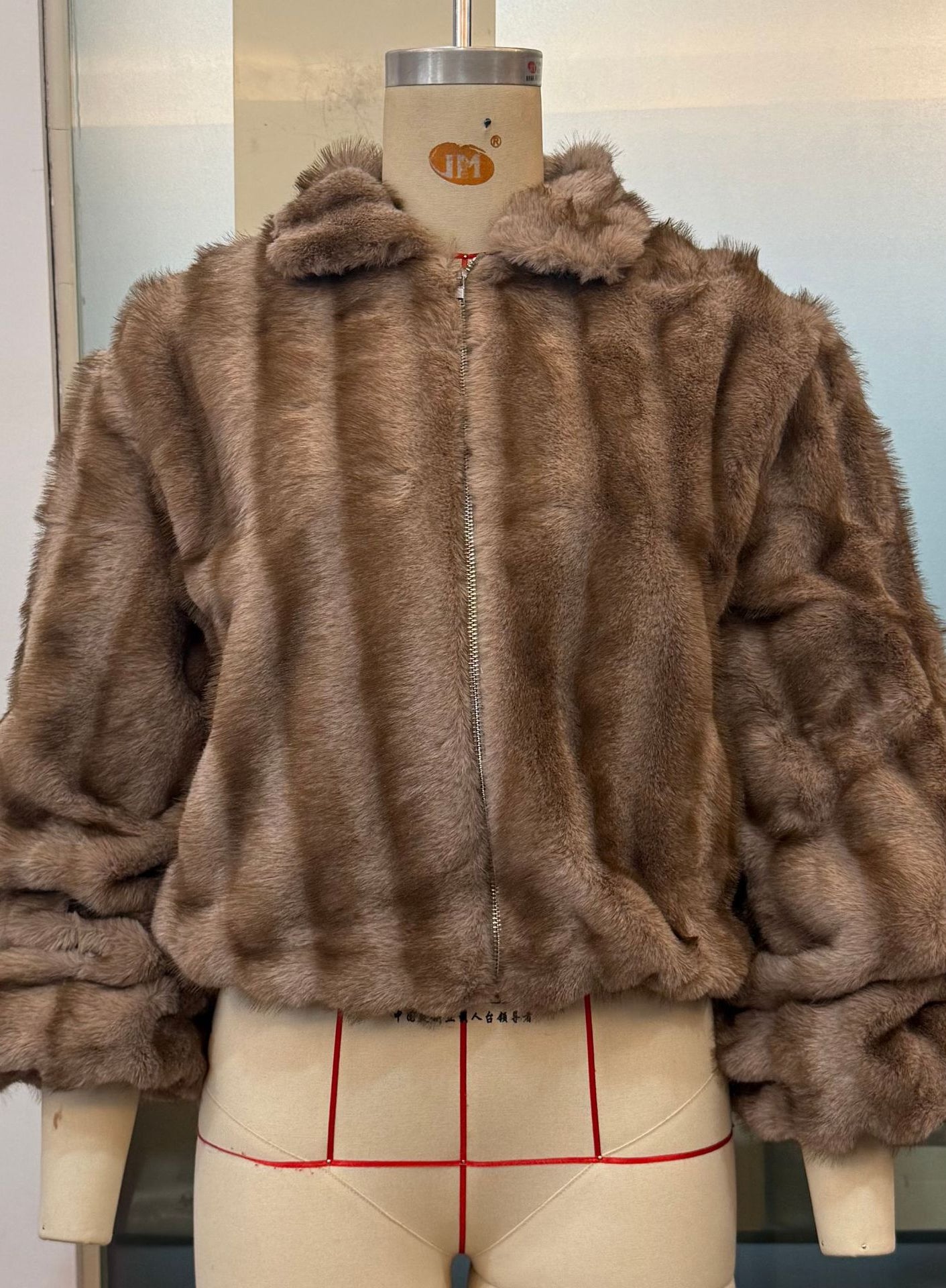 Loose warm faux fur jacket by Langry fashion with hood and zipper