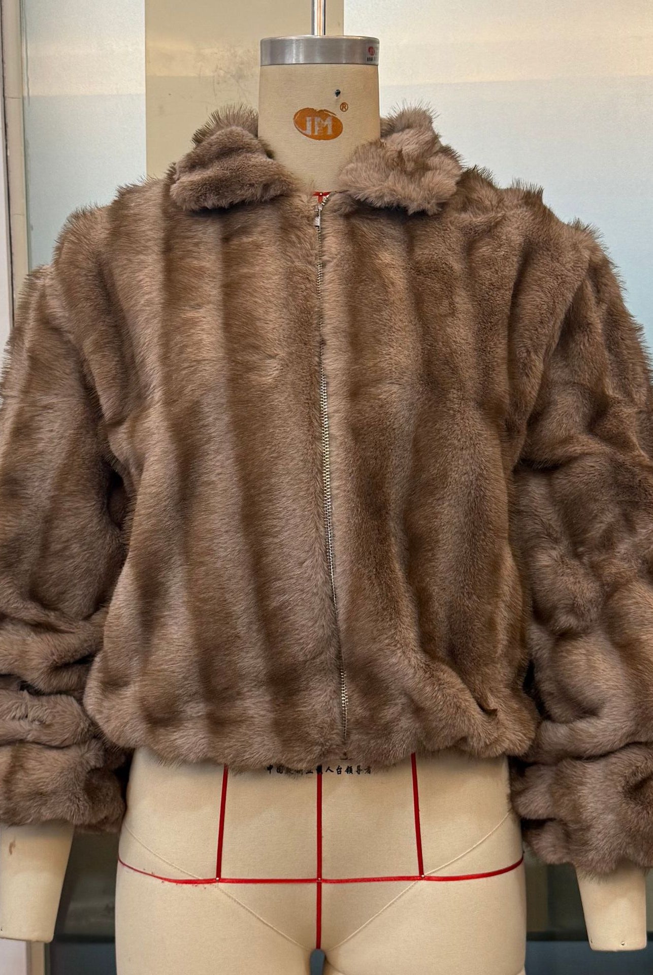 Loose warm faux fur jacket by Langry fashion with hood and zipper