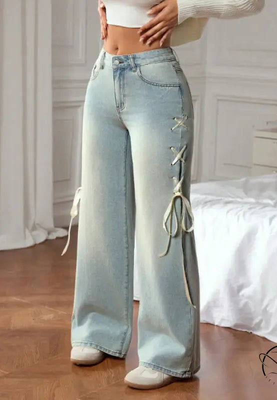 Casual wide leg jeans with light-wash denim and white lace-up detailing
