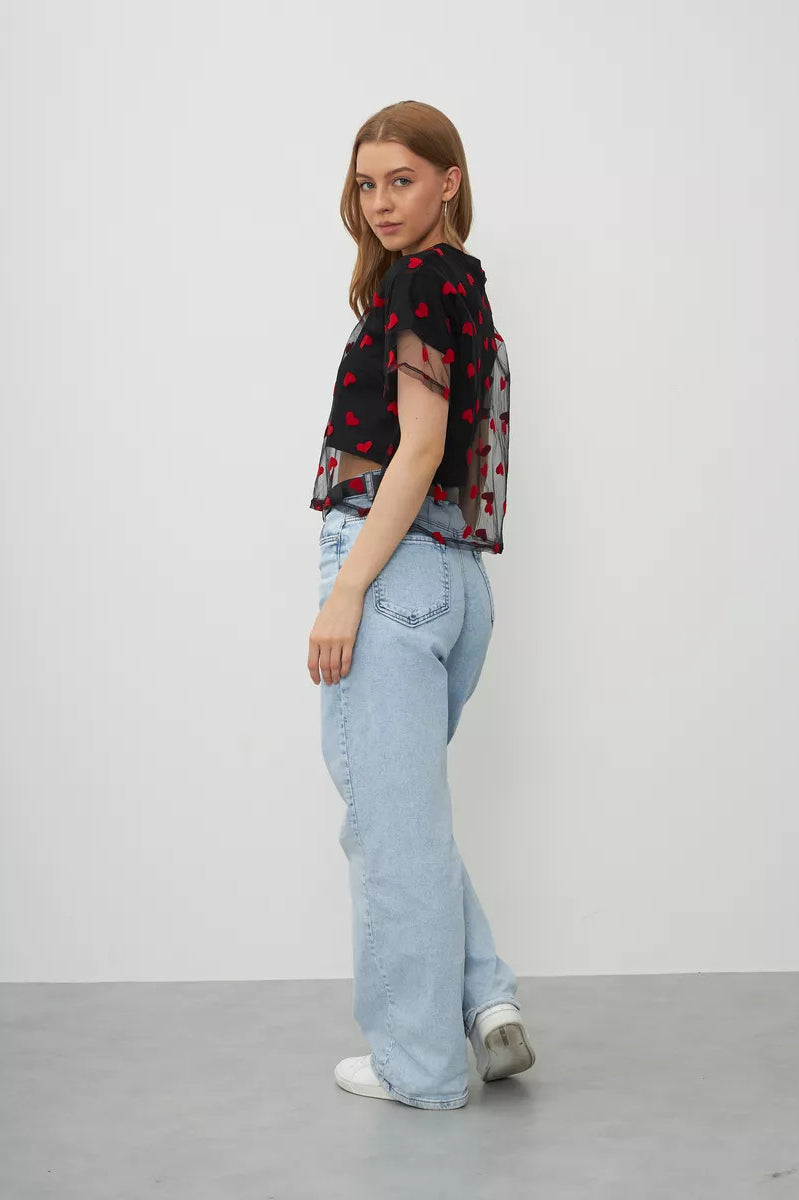 Person in light blue jeans and floral top showcases Elegant Faux Two Piece Cotton Short Top