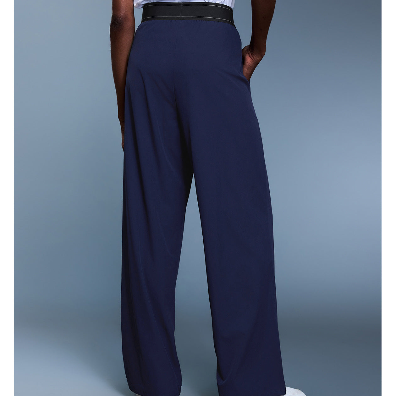 Navy blue langry fashion trousers with black waistband and white sneakers