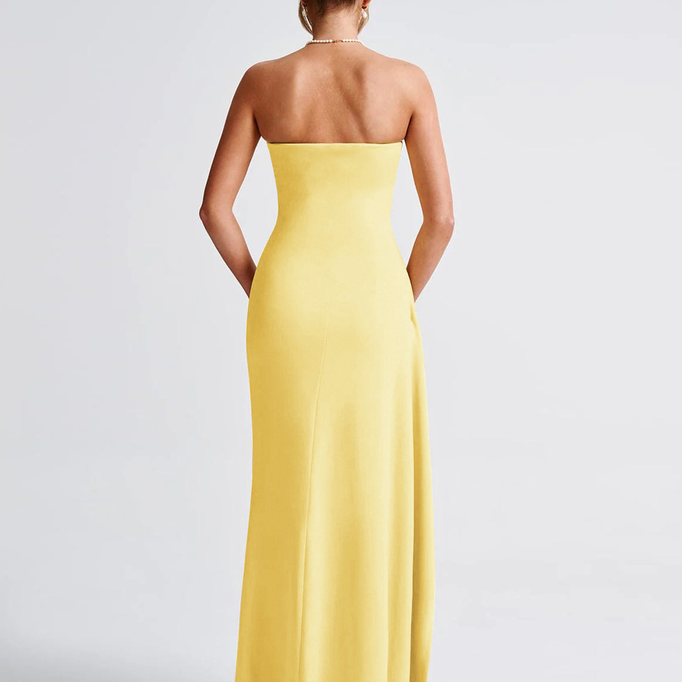 Back view of a strapless yellow gown in fashion at Langry ملابس collection