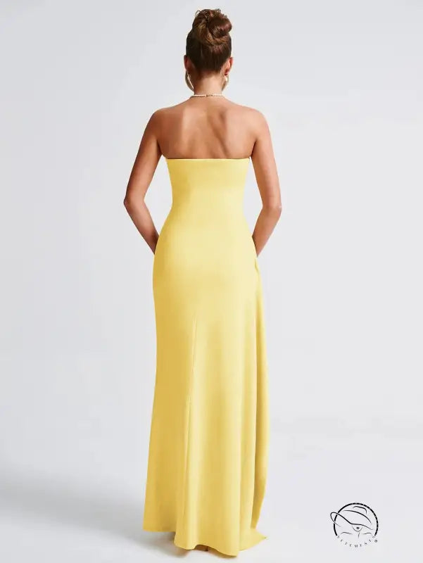 Back view of langry strapless yellow fashion gown with side slit
