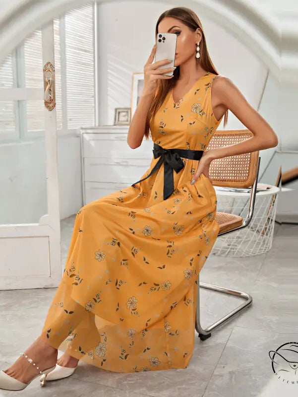 Elegant long langry fashion dress in mustard yellow with floral pattern and black sash