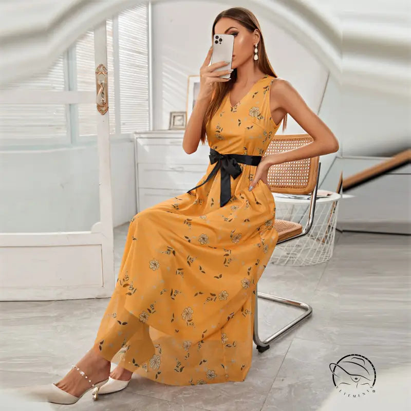 Elegant long langry fashion dress in mustard yellow with floral pattern and black sash