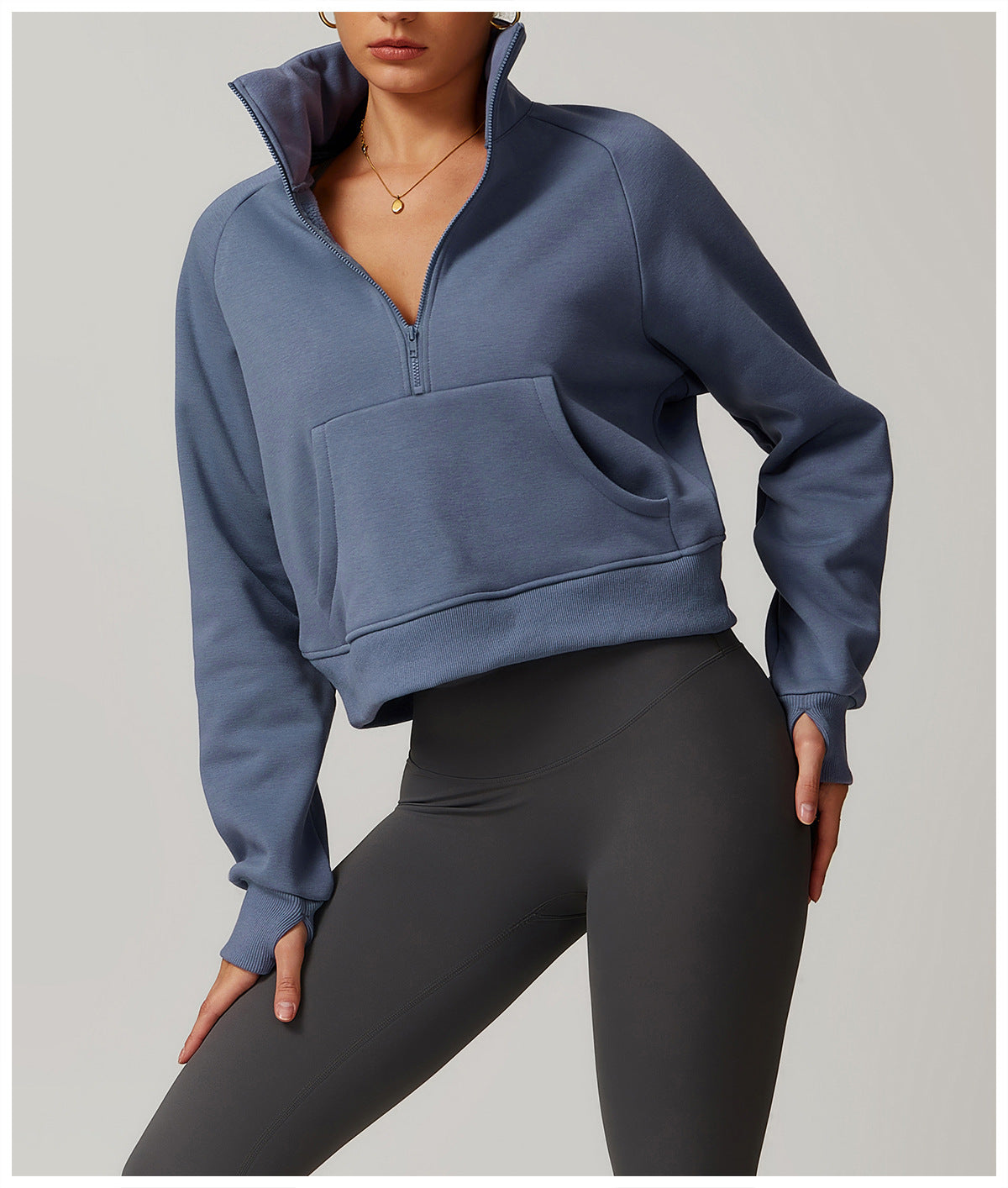 Cropped blue-gray quarter-zip sweatshirt with front pocket, paired with black leggings for langry fashion
