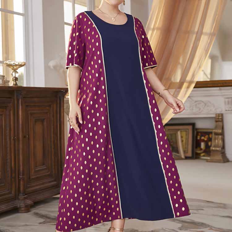 Plus-size maxi dress with navy blue center, maroon polka dot side panels, and short sleeves
