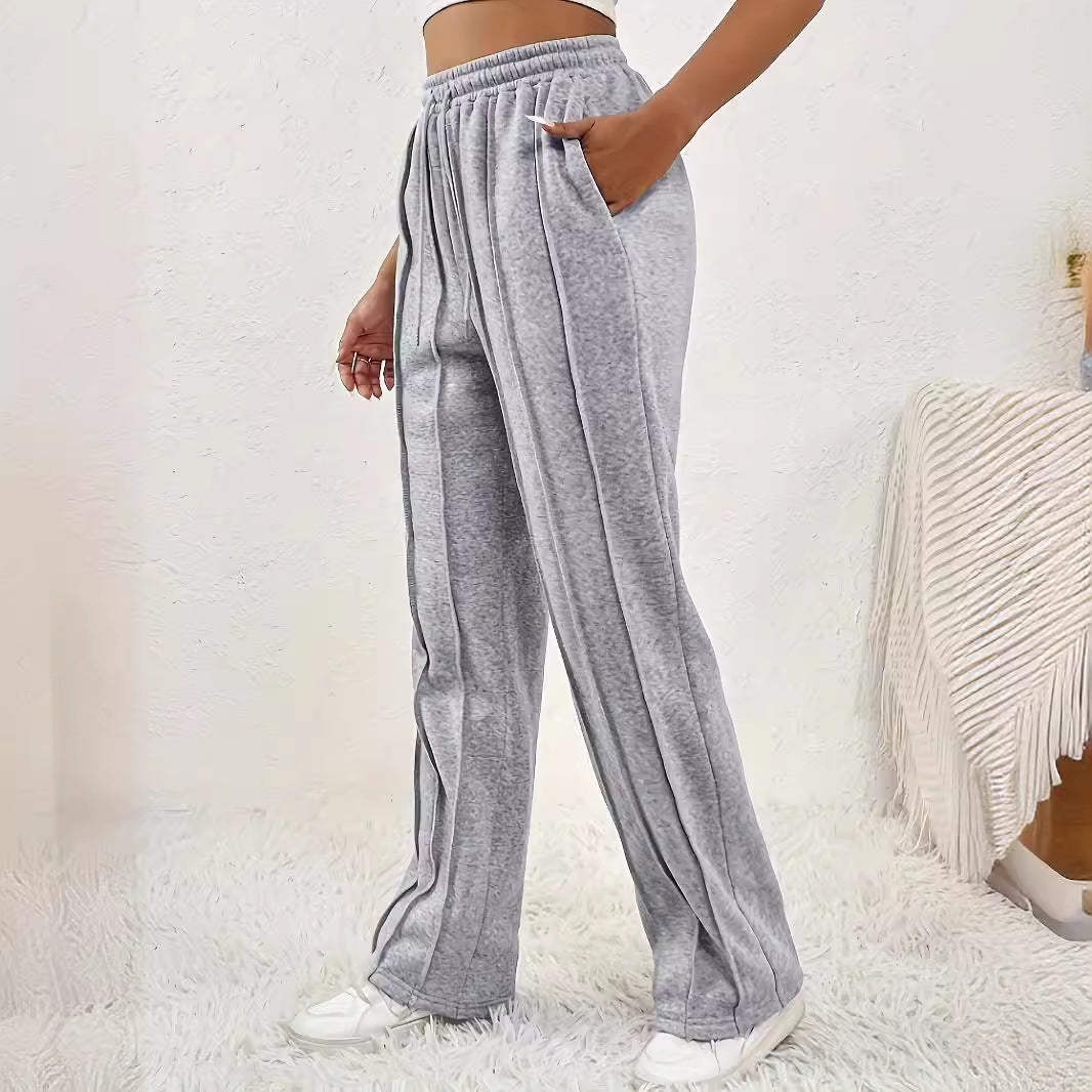 Gray sweatpants with vertical seam lines and pockets, ideal for wide leg fashion