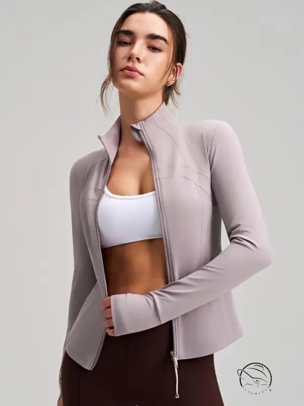 Long sleeve lavender zip-up yoga jacket with drawstring hem, pockets, and finger stalls