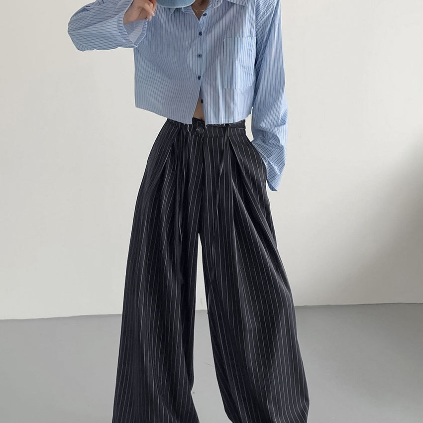Light blue pinstriped cropped button-up shirt with dark pinstriped loose drooping casual work pants