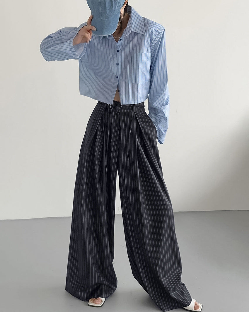 Light blue pinstriped cropped button-up shirt with dark pinstriped loose drooping casual work pants