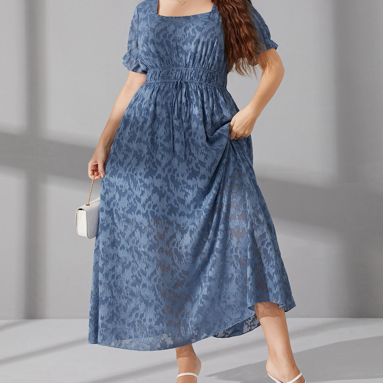 Elegant long blue midi dress with elastic waist, puff sleeves, and subtle pattern