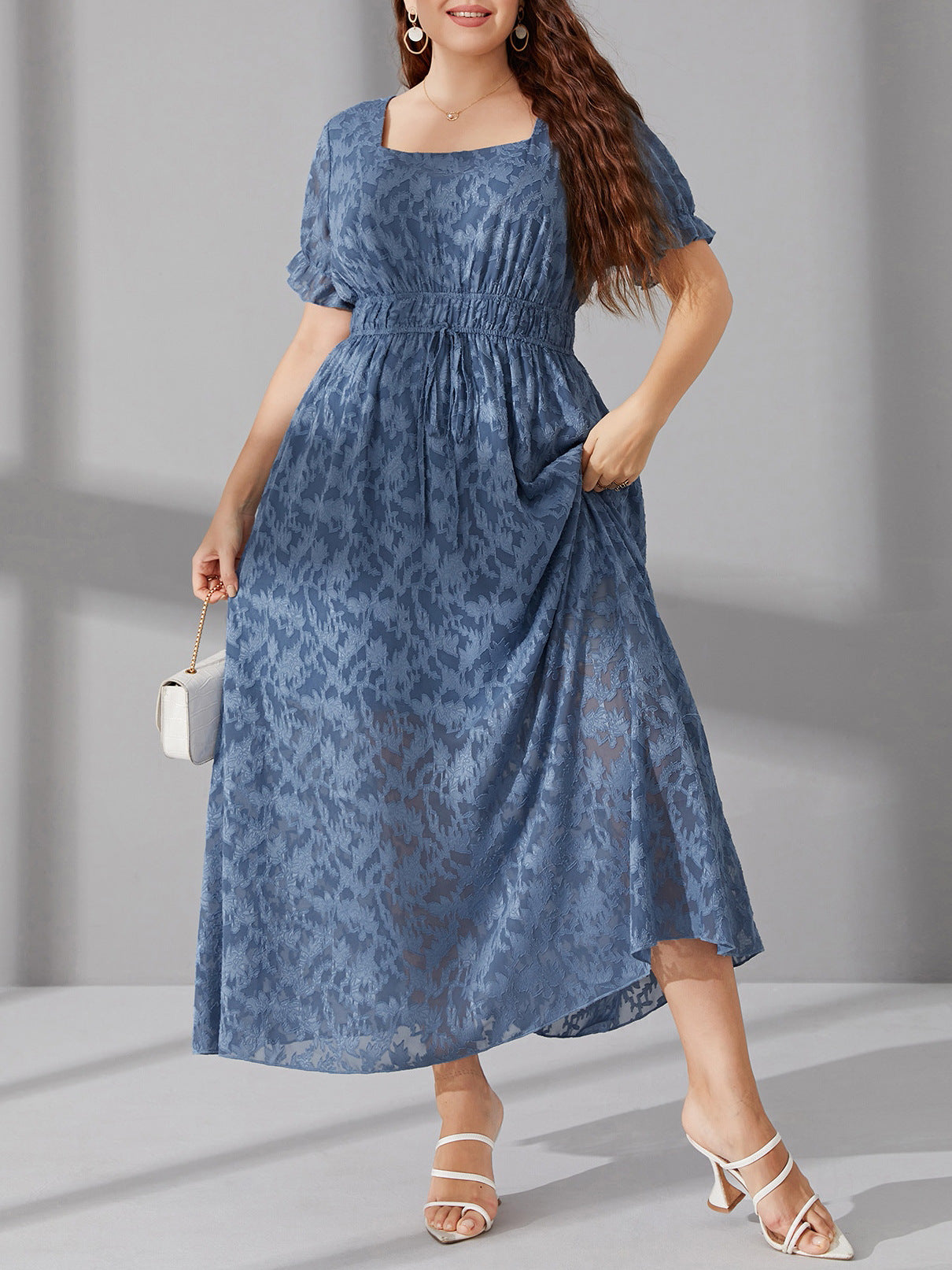 Elegant long blue midi dress with elastic waist, puff sleeves, and subtle pattern