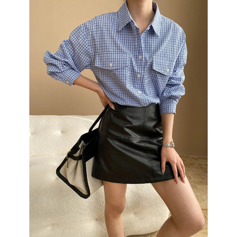 Blue and white checkered long sleeve shirt styled with black leather mini skirt