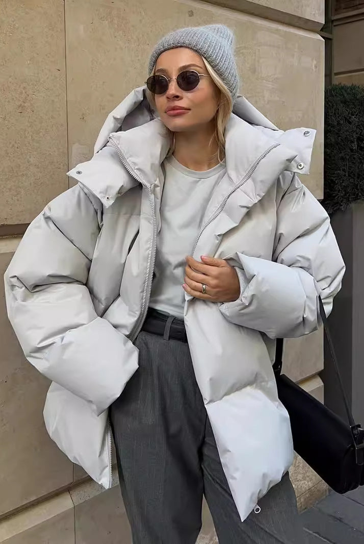 Woman wearing a gray puffer jacket from Langry, stylish ملابس for chilly weather